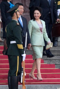 Chinese first lady Peng Liyuan, right, and Chinese President Xi Jinping arrive for a welcome ceremony for the Sri Lankan President, unseen held at the Great Hall of the People in Beijing, China, Tuesday, May 28, 2013. (AP Photo/Ng Han Guan)